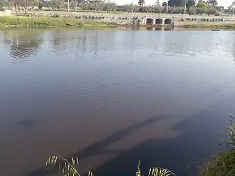 A body of water with a bridge in the distance.