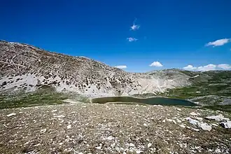 A body of water surrounded by mountains.