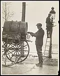 Street scene depicting two lamplighters