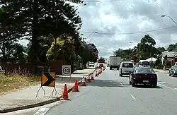 Cone taper for left lane closure in Western Australia showing small chevron (shifter), 40 km/h repeater, chevron and arrow-board