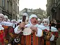The Gilles putting on their masks to reach the main square