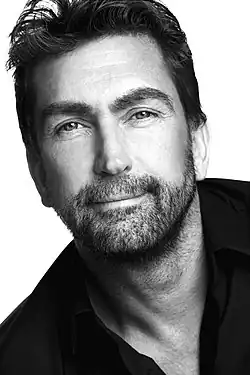A middle-aged man looking at the camera
