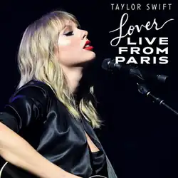 Photo of Swift closing her eyes, dressed in black, with a mic next to her