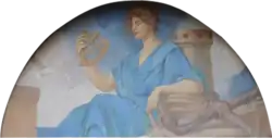 Woman dressed a goddess/deity holding sexton leaning on rope and anchor with lighthouse in background.