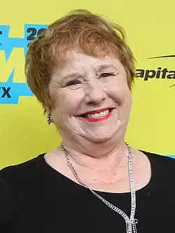 Stewart standing and smiling on the red carpet
