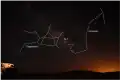 M7 on the night sky. It is easily visible to the naked eye and located between the constellations Scorpius and Sagittarius.