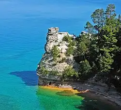 Rounded rock tower jutting into the lake