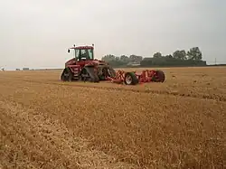 Trailed mole plough with double agitator legs