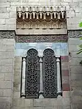 One of the windows, with wooden screens carved in arabesque openwork