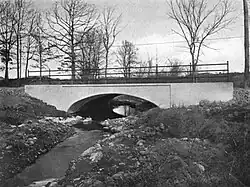 An arch bridge over a stream