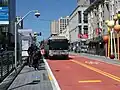A bus stop with bus in the median of an urban arterial