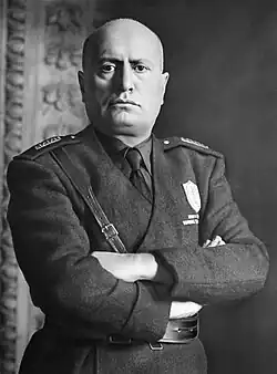 Black-and-white portrait photograph of Mussolini crossing his arms