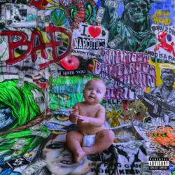 A baby sitting cross-legged in a room covered with colorful stickers, graffiti and artwork on the floor and walls.