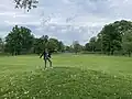 Man on top of the central mound at the Great Circle in 2024