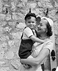 Smiling while holding her son in her arms