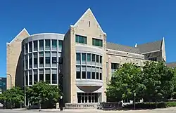Modern four-story building of smooth stone and concrete