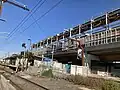 Eastbound view of former ground level Platform 2, showing new elevated station under construction, March 2024