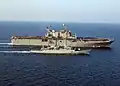 PNS Badr steams alongside USS&nbsp;Tarawa, an amphibious assault ship, in the Northern Persian Gulf, participating in the relief operation for the earthquake that struck the northern part of the Pakistan on 8 October 2005.