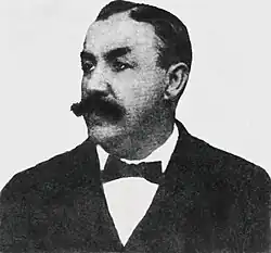 Portrait photograph of a man with mustache and bowtie