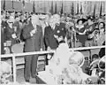 Presidents Dutra and Truman sampling a birthday cake decorated with Brazilian and U.S. flags.