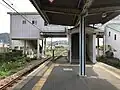 The station platform looking west. Note the stairwell leading to the station building above the tracks and also the station entrances (stairwells) on both sides.