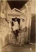 Galdi as a boy seated on a lararium at Pompeii