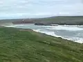 View eastwards over Porth Trecastell cove from the side of Barclodiad y Gawres