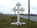 The monument to Roberts Mūrnieks features an auseklis cross