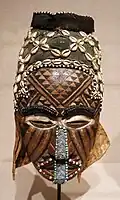 Ngaad-A-Mwash mask; by artists of the Kuba people; late 19th-early 20th centuries; wood, shells, glass beads, raffia and pigment; height: 82&nbsp;cm; Detroit Institute of Arts, Detroit, Michigan, US[107]