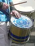 Repinique being played with a stick and a hand
