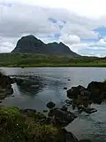 River Kirkaig. For a short distance after it leaves Fionn Loch the river meanders before garthering speed and tumbling down the Falls of Kirkaig. Caisteal Laith the highest summit of Suilven dominates the scene.