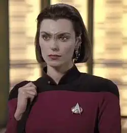 Ensign Ro in the transporter room of the Enterprise