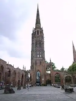 The surviving tower and steeple, which functions as a working bell tower