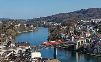 An SBB Red Arrow double railcar crossing the Feuerthalen Rhine bridge&nbsp;[de] between Feuerthalen (right) and Schaffhausen (left)