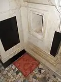 One of the side recesses of the altar of the Crucifix. Note the cushion set up on the floor for kneeling.