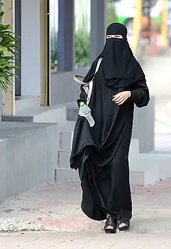 Image 14Saudi woman wearing a niqāb in Riyadh. Many women commonly wear a niqab or a burqa in Saudi Arabia. (from Culture of Saudi Arabia)