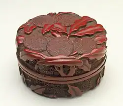 Yinni He (Seal Paste Box) with Litchi Stems, 7.5&nbsp;cm wide, Middle Ming, 1450–1500. Brocade-ground patterns are used both for the background and on the fruit.