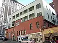 The upper portion of the Drexel Hotel Building is a wood-framed structure that predates the great fire, but it was re-clad with new materials after 1945