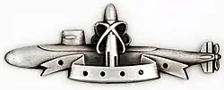 Silver SSBN Deterrent Patrol insignia, depicting a nuclear submarine with a superimposed ballistic missile, framed by lines reminiscent of an atomic nucleus, indicating the missiles contain nuclear warheads.