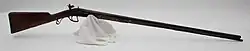 English or French smoothbore flintlock shotgun with an engraved iron mounting
