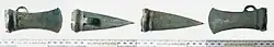 a photo of four sides of a socketed axe head