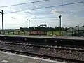 Platform 2, a meadow behind it.