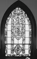 Miniature submarine in lower portion of stained glass window