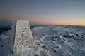 The base of a survey trig marker at the summit
