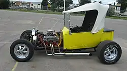 Ford T-bucket based hot rod. Also features dropped tube axle, transverse front leaf spring, and front disc brakes.