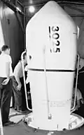Securing cover for TIROS V satellite prior to launching