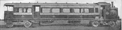 Steam railmotor, a passenger coach combined with a small locomotive. The smokebox door is prominent in the side of the locomotive.