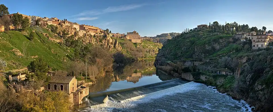 Image 2 Tagus River Photo credit: David Iliff The Tagus River, seen here passing through the World Heritage listed city of Toledo, Spain. It is the longest river on the Iberian Peninsula at 1,038 kilometres (645&nbsp;mi). It begins its journey in the Albarracín mountains in Spain, and follows a very constricted course for much of its length before reaching the Atlantic Ocean in Portugal. More selected pictures