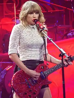 Woman playing a red guitar