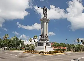Henry Rosenberg contributed this statue to the citizens of Galveston. It was a memorial to the heroes of the Texas Revolution. A dedication ceremony was held on San Jacinto Day, April 21, 1900, and featured a parade and ceremonies attended by Governor Joseph D. Sayers. The monument was created by Italian-American sculptor Louis Amateis. It is made of bronze and granite and features the female form of Victory holding a laurel wreath in an outstretched arm pointing to the San Jacinto Battleground across the bay, where Sam Houston defeated Santa Anna, winning independence for the Republic of Texas.